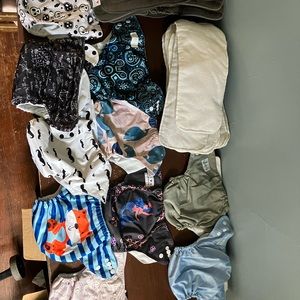 Ten (10) cute cloth diapers - a combination of plain and print.  With liners.